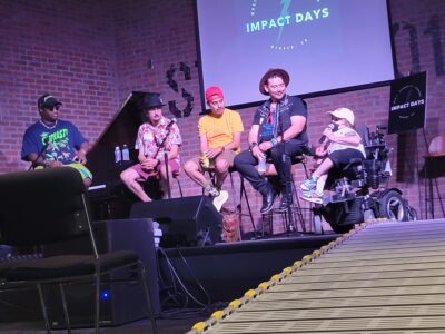 A photo take from a ramp of a panel of 4 artists during Impact Days at The Underground Music Showcase