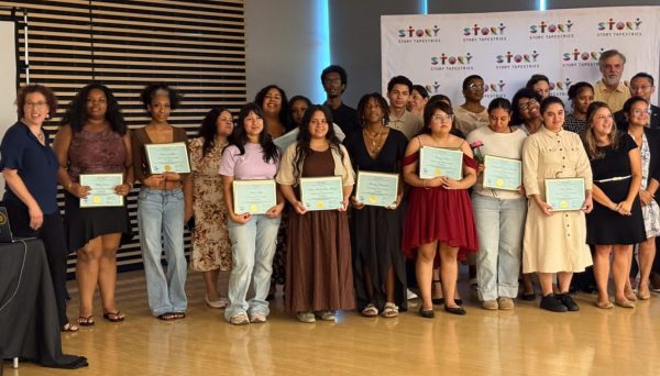 Participants and Educators in front of a Step and Repeat that says Story Tapestries.